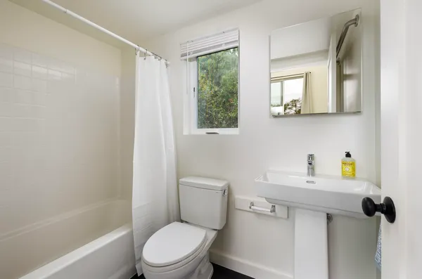 a bathroom with a sink toilet and shower