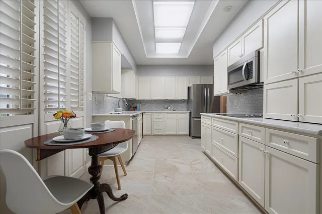 a kitchen with stainless steel appliances kitchen island granite countertop a sink and cabinets