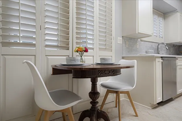 a kitchen with a table chairs and a refrigerator