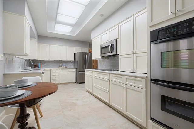 a kitchen with a sink appliances and cabinets