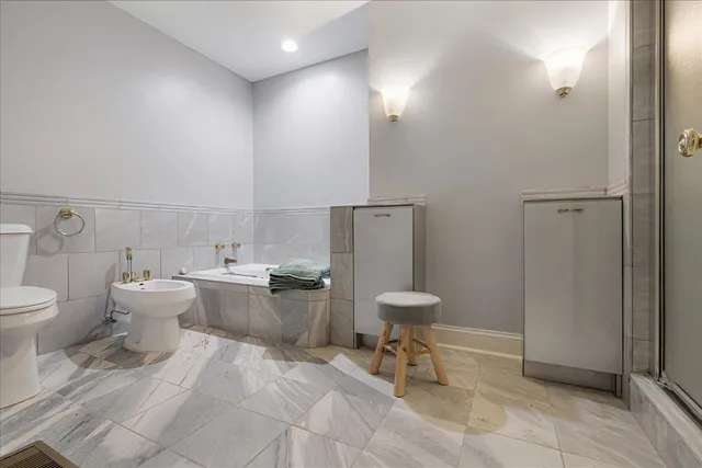 a bathroom with a toilet sink and mirror