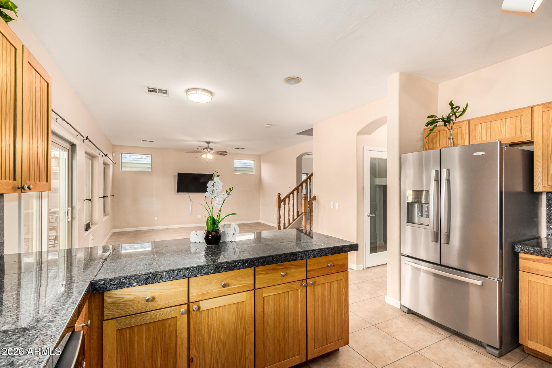 25660 West Dunlap Road Buckeye, AZ 85326 - Photo 12 of 40 a kitchen with stainless steel appliances granite countertop a refrigerator and a sink