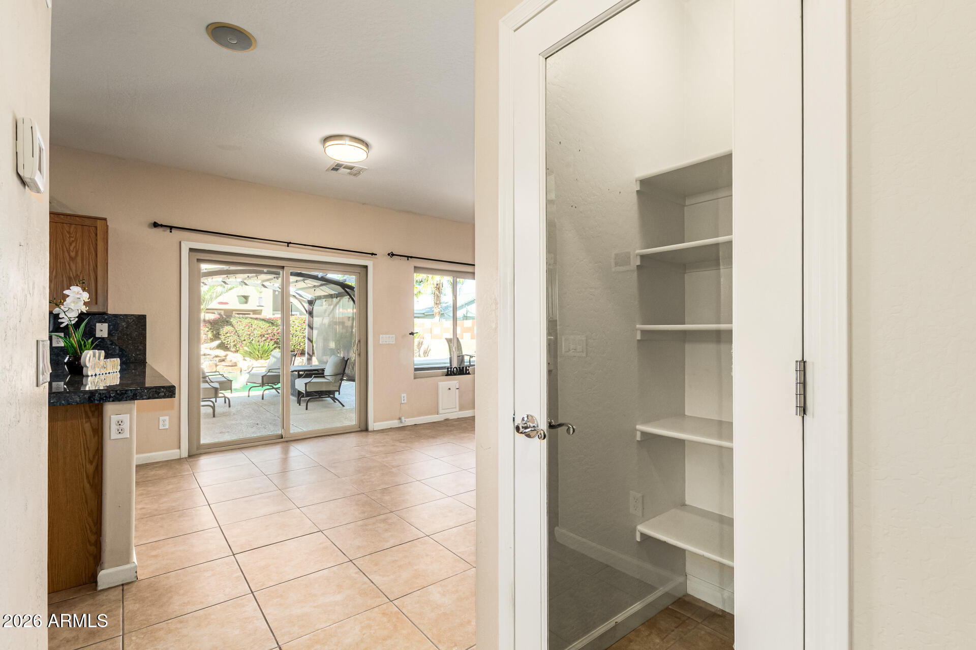 25660 West Dunlap Road Buckeye, AZ 85326 - Photo 13 of 40 a living room with furniture a flat screen tv and a window