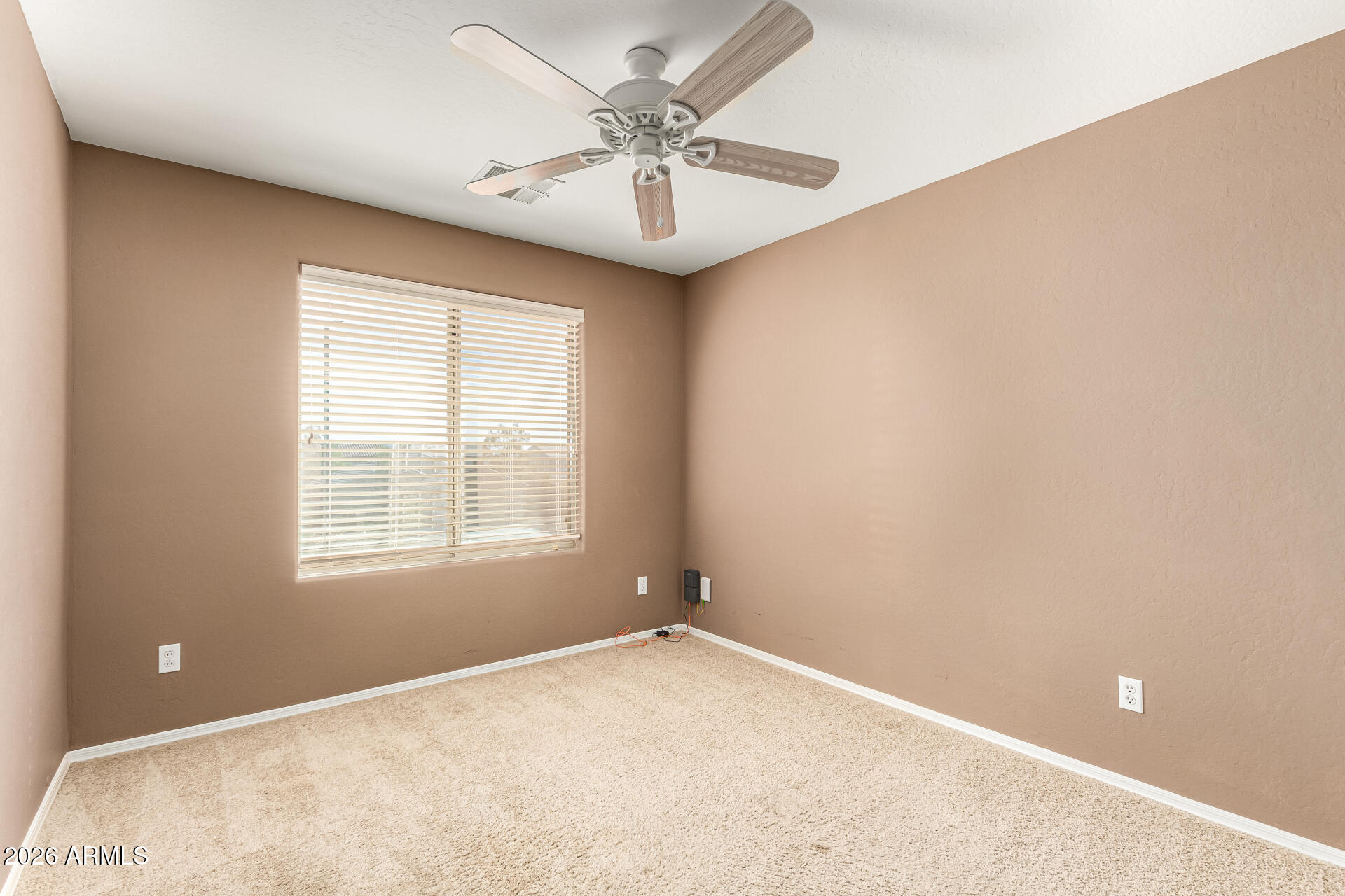 25660 West Dunlap Road Buckeye, AZ 85326 - Photo 27 of 40 an empty room with windows and ceiling fan