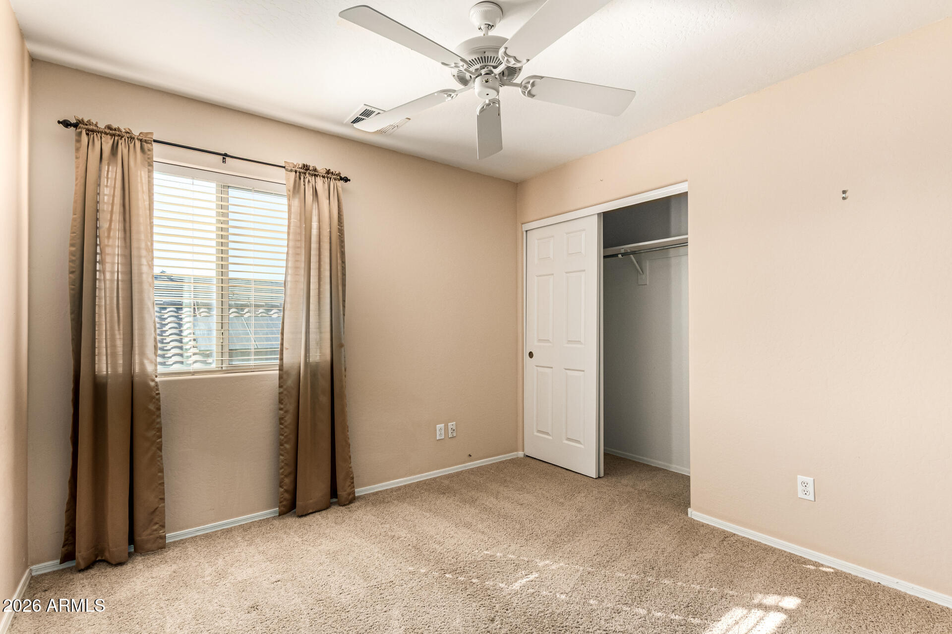 25660 West Dunlap Road Buckeye, AZ 85326 - Photo 29 of 40 a view of a livingroom with a ceiling fan and window