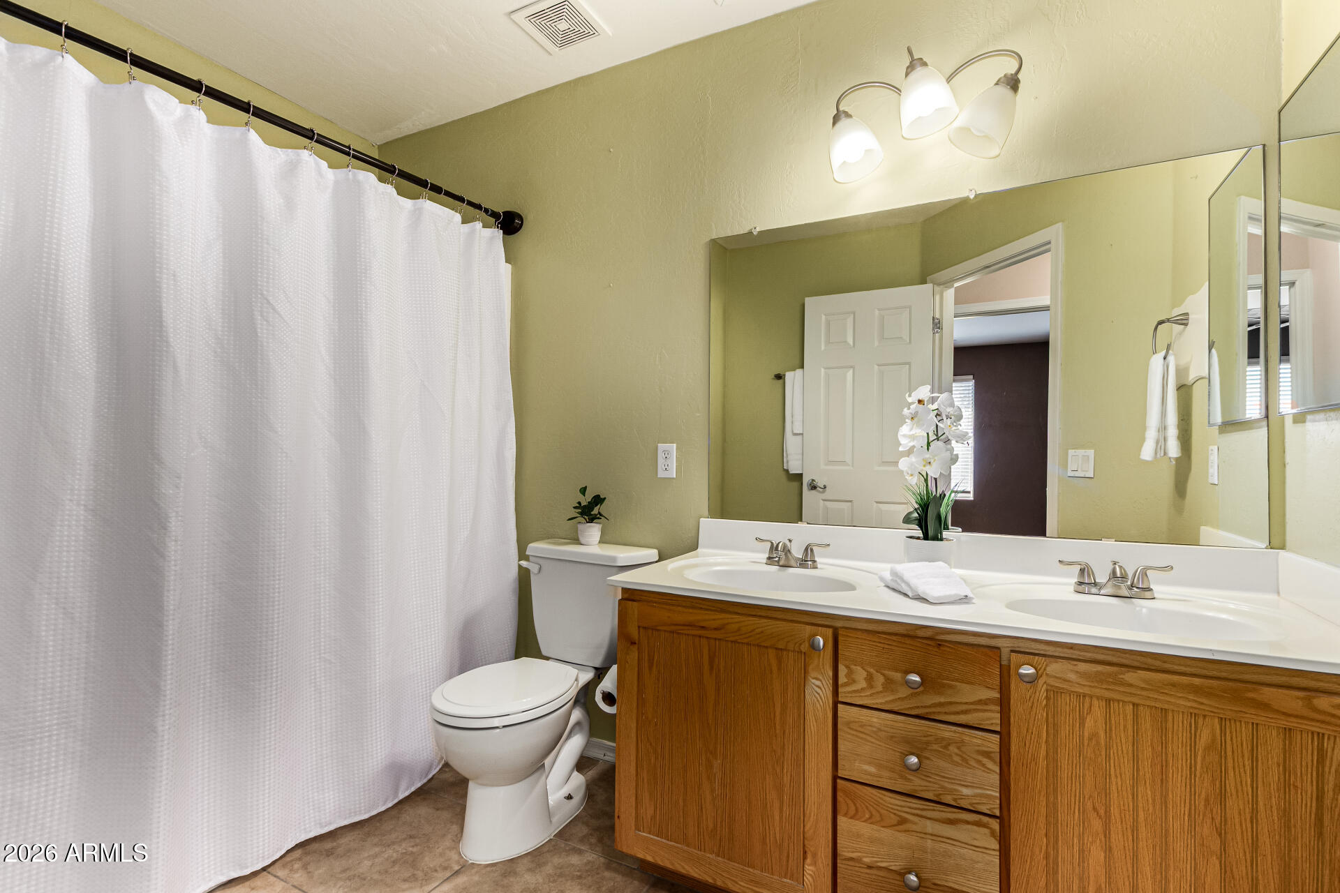25660 West Dunlap Road Buckeye, AZ 85326 - Photo 31 of 40 a bathroom with a double vanity sink toilet mirror and shower