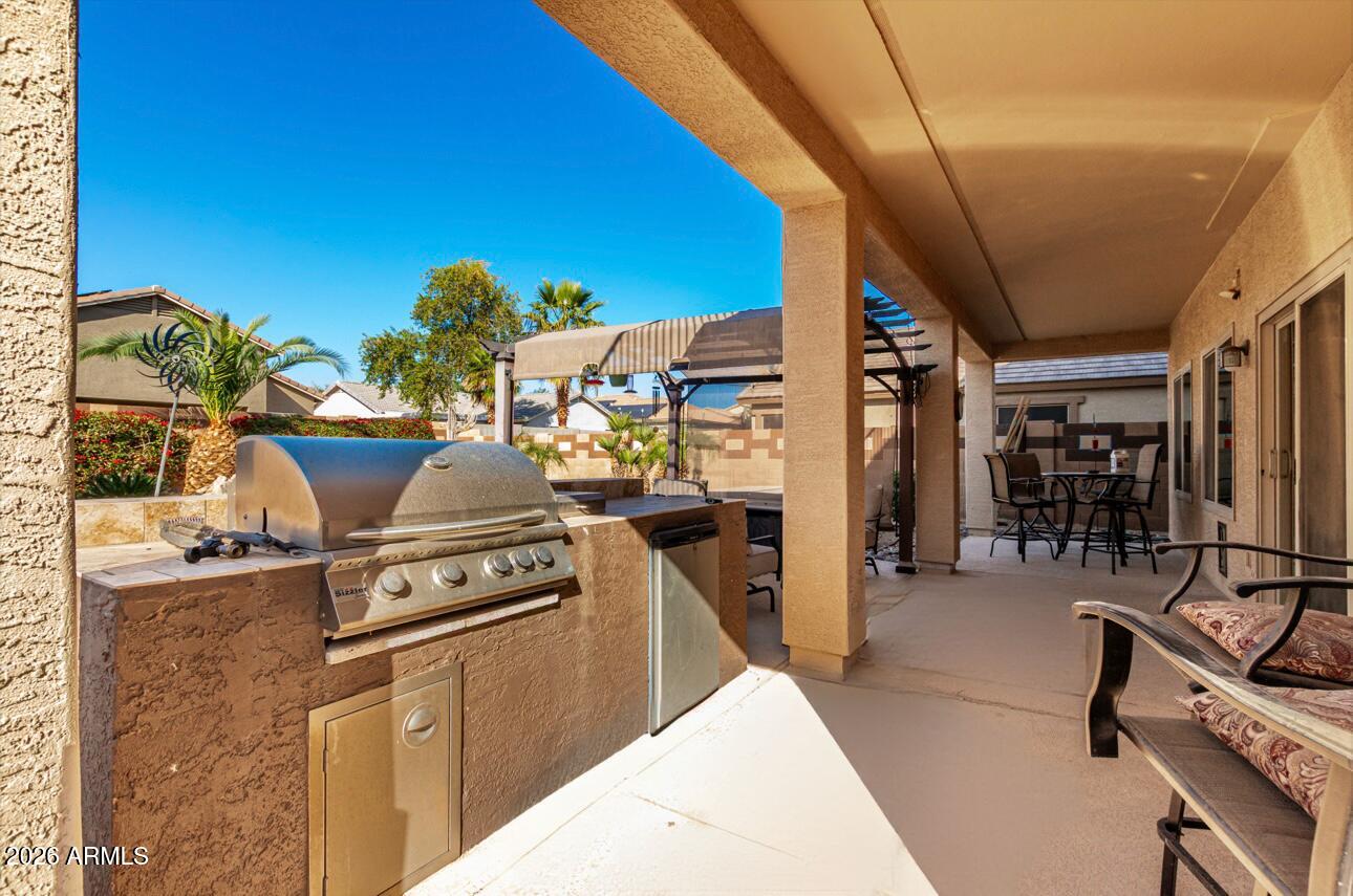 25660 West Dunlap Road Buckeye, AZ 85326 - Photo 36 of 40 a kitchen with a stove and a refrigerator