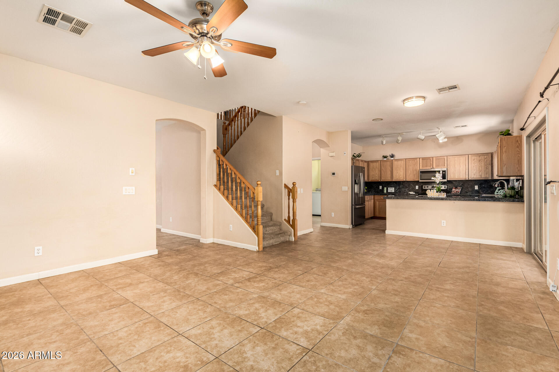 25660 West Dunlap Road Buckeye, AZ 85326 - Photo 9 of 40 a view of a kitchen with a sink and a refrigerator