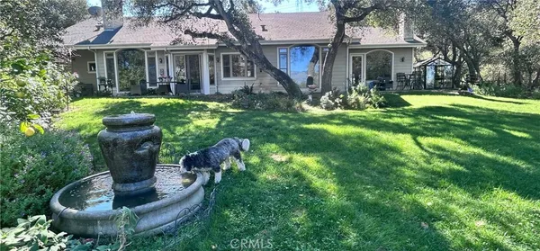 a front view of a house with a yard fountain and fountain