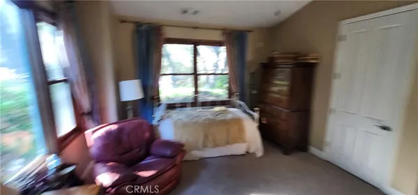 a bedroom with bed and a window