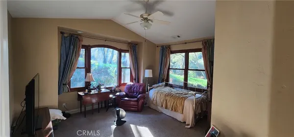 a living room with furniture and a floor to ceiling window
