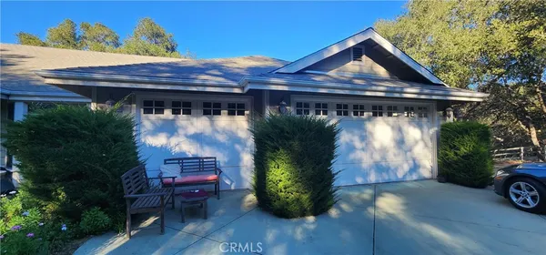 a view of house with backyard and outdoor seating