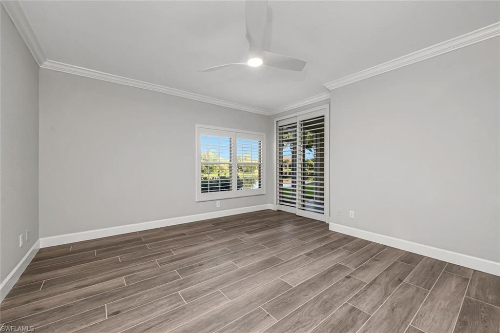 10771 Crooked River Road, Unit 103 Estero, FL 34135 - Photo 14 of 21 a view of an empty room with wooden floor and a window