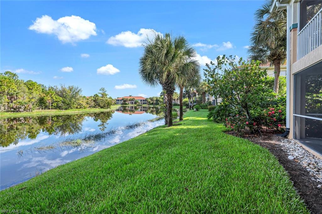 10771 Crooked River Road, Unit 103 Estero, FL 34135 - Photo 17 of 21 a view of a lake with a yard