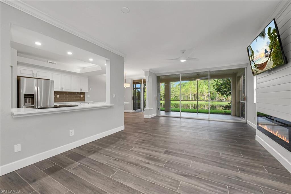 10771 Crooked River Road, Unit 103 Estero, FL 34135 - Photo 3 of 21 a view of empty room with wooden floor and fireplace