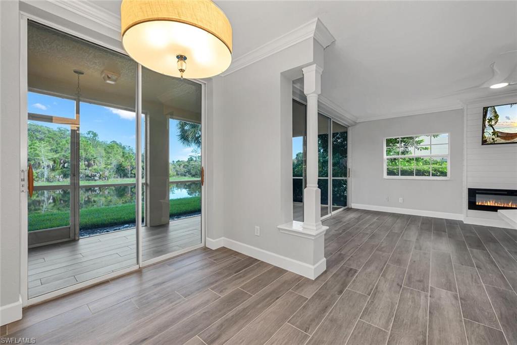 10771 Crooked River Road, Unit 103 Estero, FL 34135 - Photo 5 of 21 a view of an entryway with wooden floor and door
