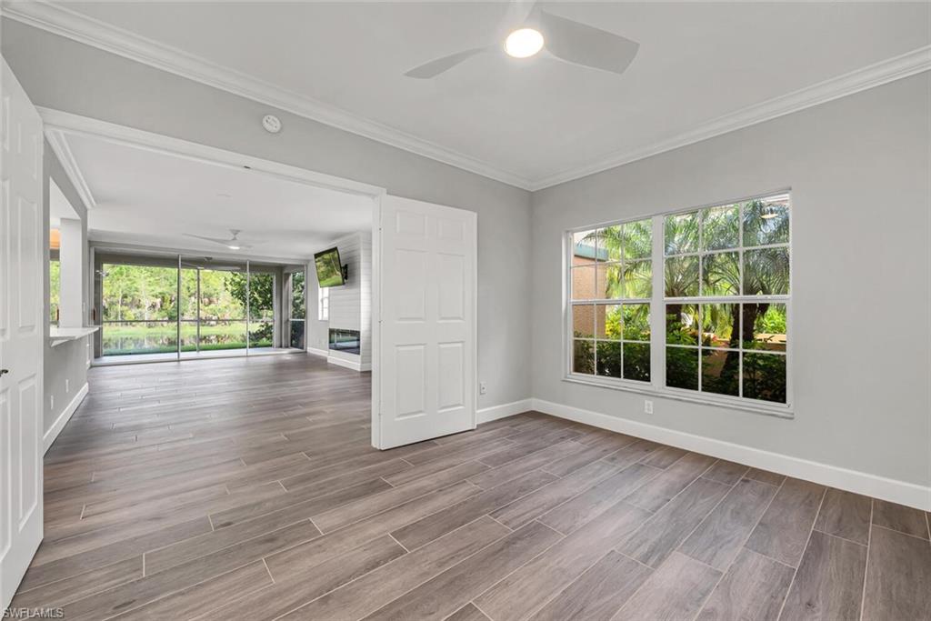 10771 Crooked River Road, Unit 103 Estero, FL 34135 - Photo 8 of 21 a view of an empty room with wooden floor and a window
