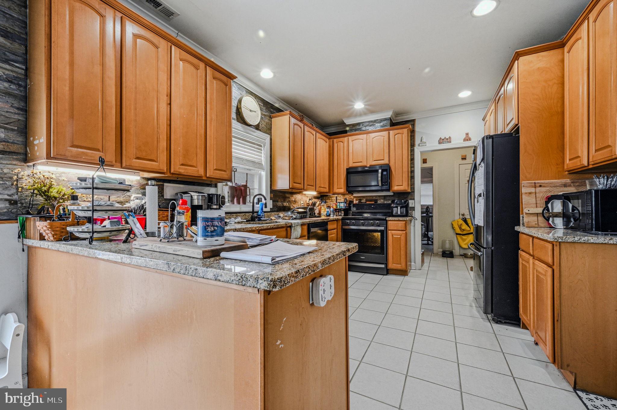 31536 Jestice Farm Road Laurel, DE 19956 - Photo 13 of 35 a kitchen with stainless steel appliances granite countertop a refrigerator sink and cabinets