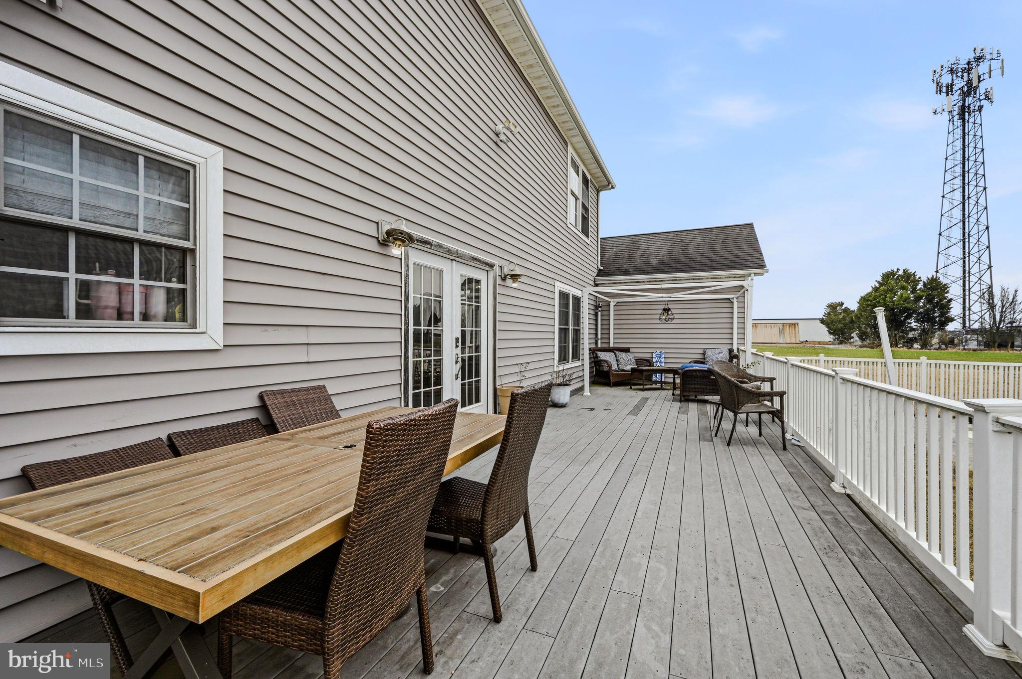 31536 Jestice Farm Road Laurel, DE 19956 - Photo 34 of 35 a view of a roof deck with table and chairs with wooden floor and fence
