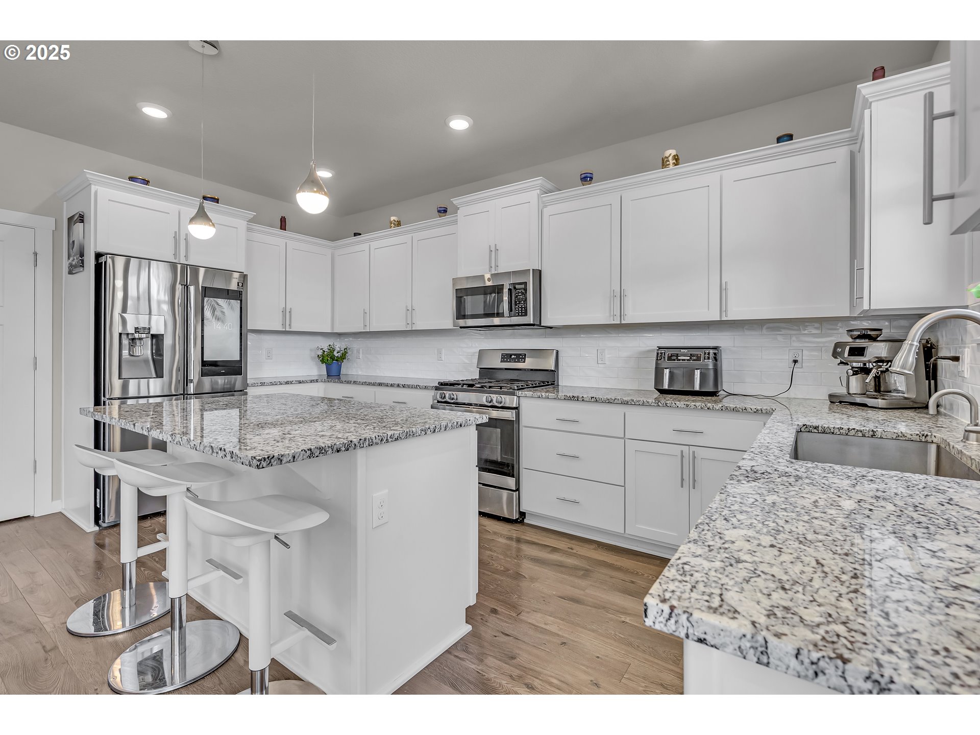 13305 Northeast 114th Way Brush Prairie, WA 98606 - Photo 13 of 40 a kitchen with kitchen island granite countertop a sink cabinets and stainless steel appliances