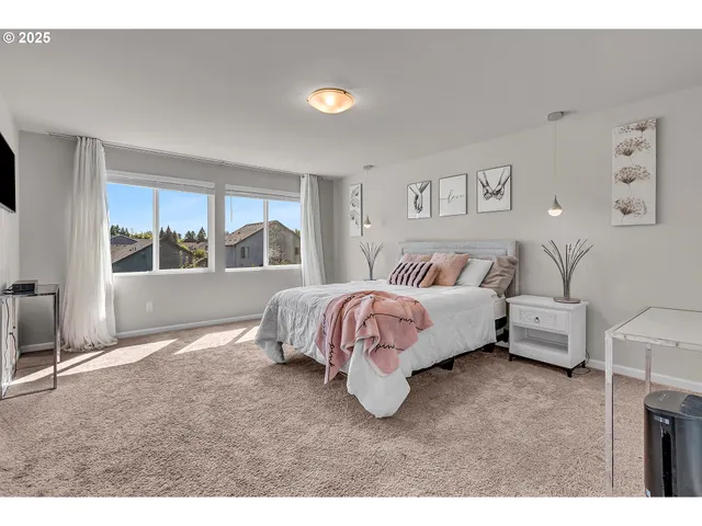 a spacious bedroom with a bed and a large window