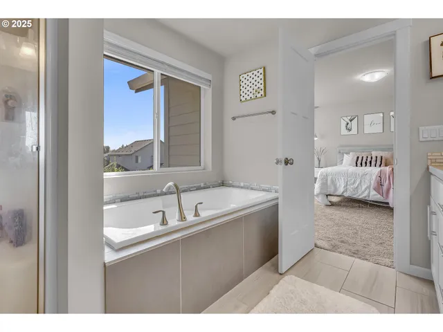 a en suite bathroom with a tub and mirror