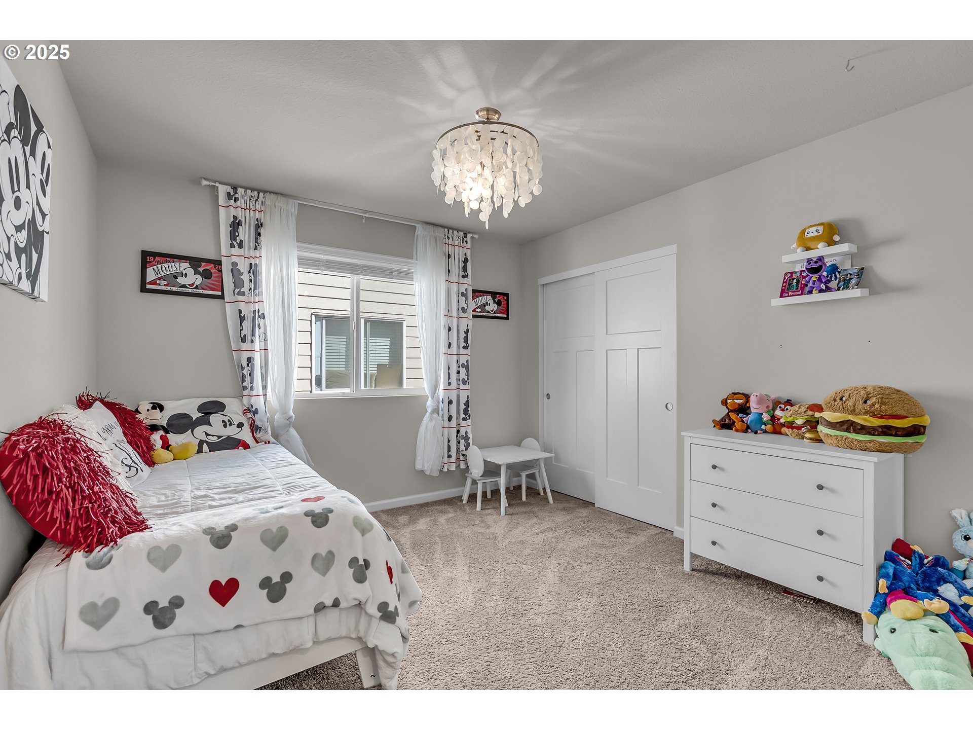 13305 Northeast 114th Way Brush Prairie, WA 98606 - Photo 27 of 40 a bedroom with a bed and a chandelier