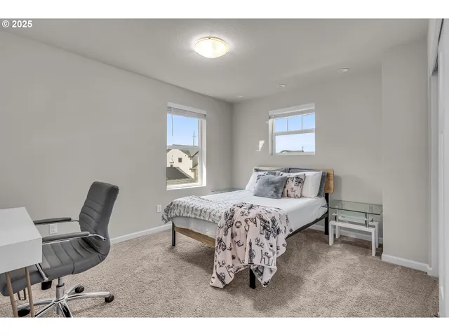 a living room with furniture a bed and a chair