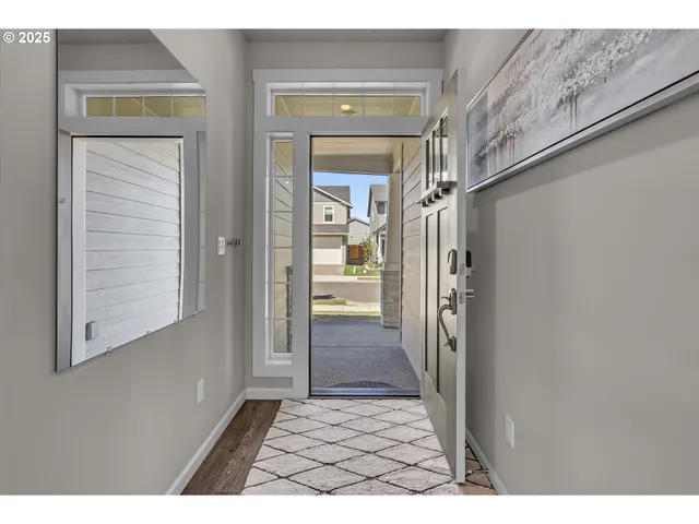 a view of a hallway view with wooden floor and a living room