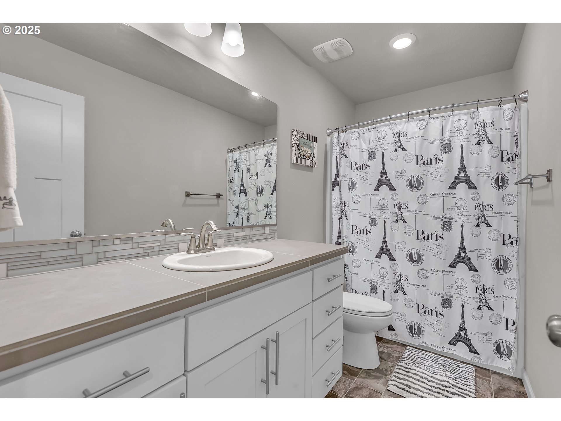 13305 Northeast 114th Way Brush Prairie, WA 98606 - Photo 31 of 40 a bathroom with a granite countertop sink a toilet and a mirror