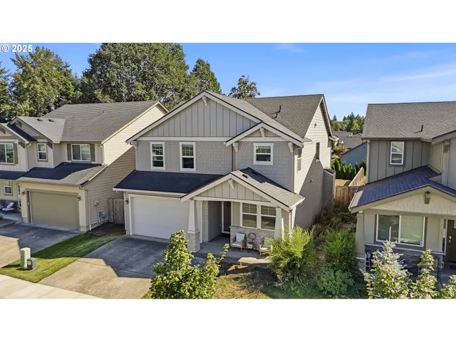 a aerial view of a house with a yard and potted plants