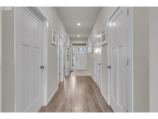 a view of hallway with wooden floor