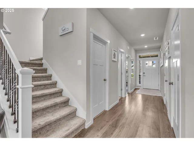 a view of an entryway with wooden floor