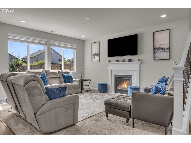 a living room with furniture fireplace and a flat screen tv