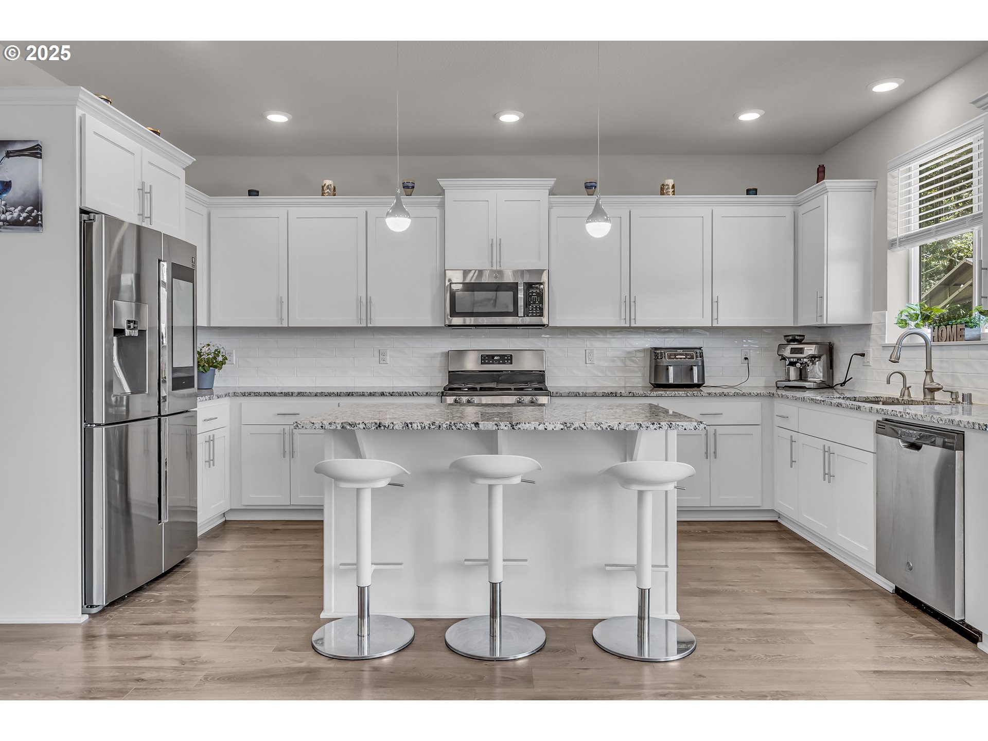 13305 Northeast 114th Way Brush Prairie, WA 98606 - Photo 10 of 40 a kitchen with stainless steel appliances granite countertop a white cabinets and a refrigerator