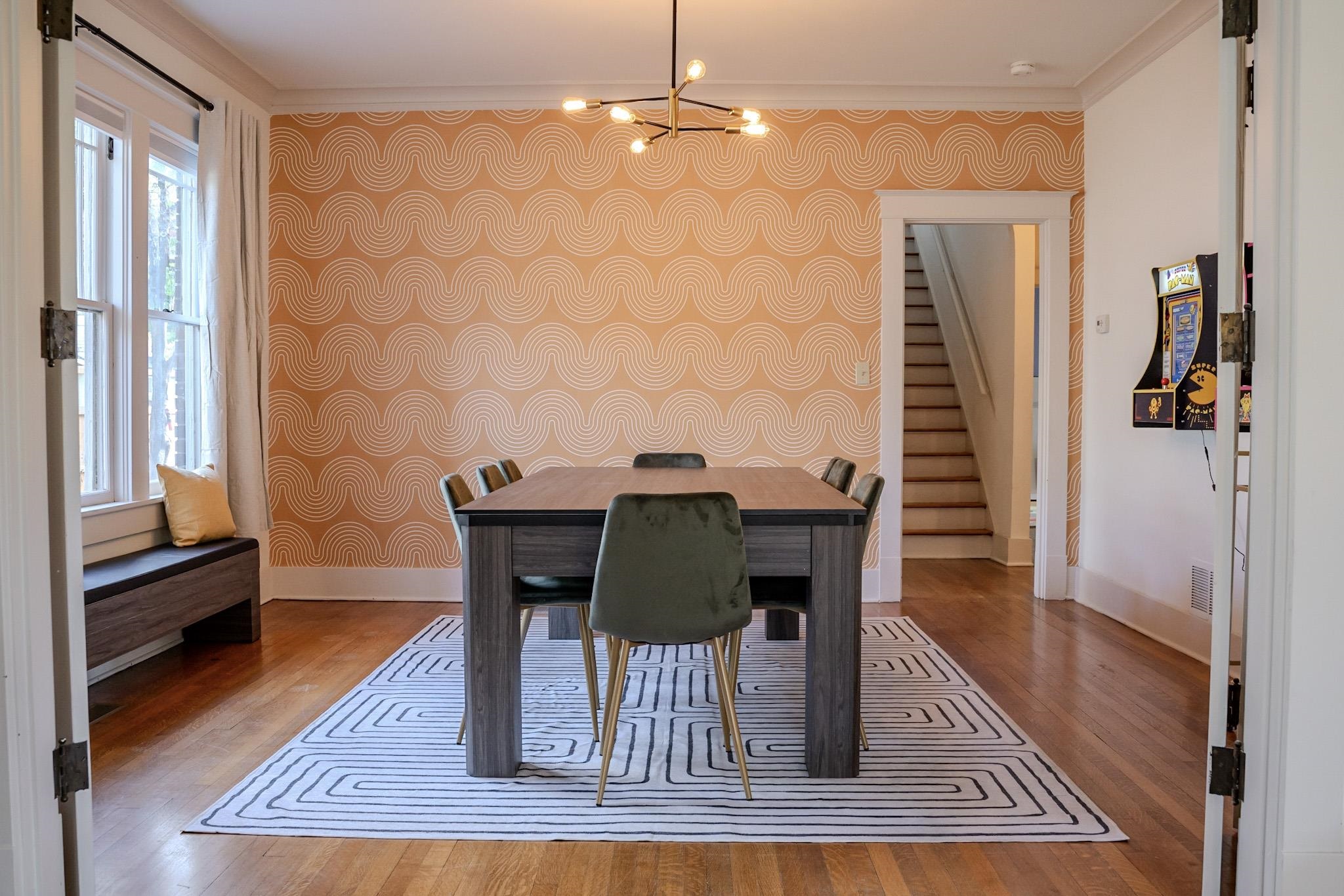 210 North Avalon Street Memphis, TN 38112 - Photo 5 of 30 Dining area featuring baseboards, stairs, wood finished floors, and a chandelier