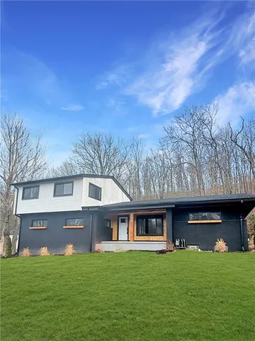 a front view of a house with a garden