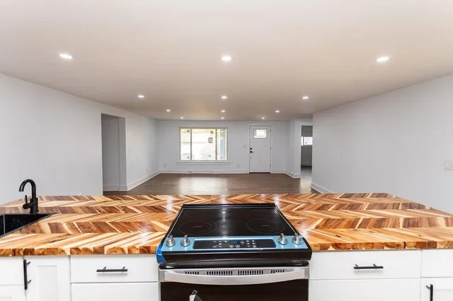 a bedroom with a bed and a view of living room