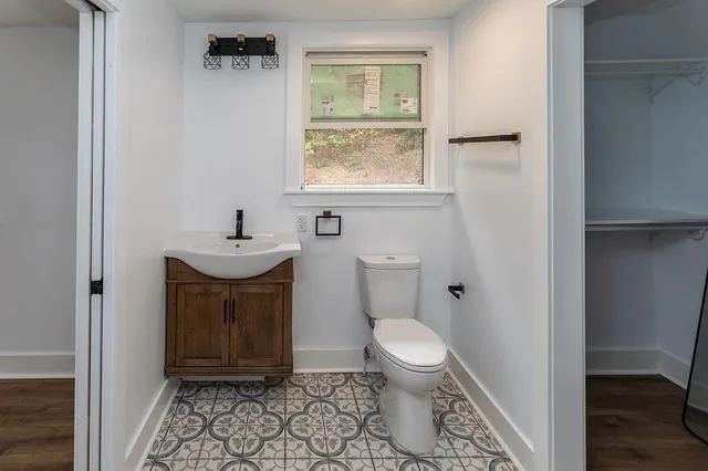 a bathroom with a toilet a sink and a window