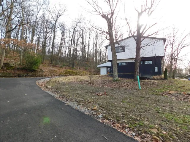 a view of a house with a yard covered with snow