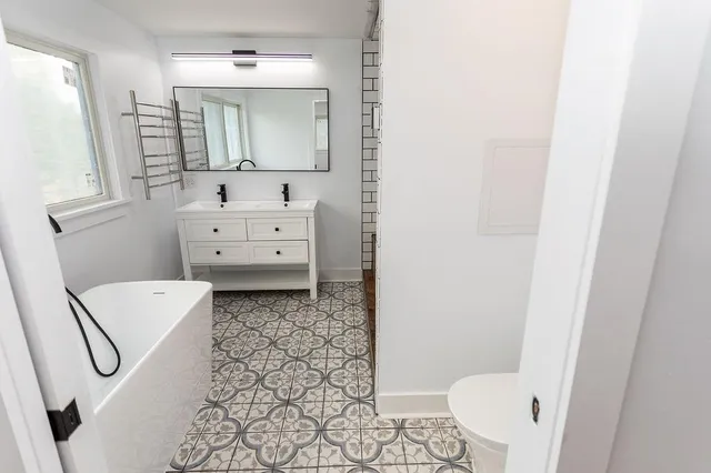 a bathroom with a toilet sink and mirror