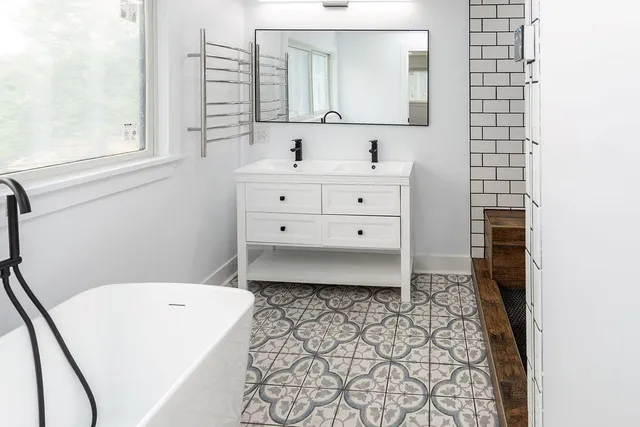 a bathroom with a sink a toilet and mirror