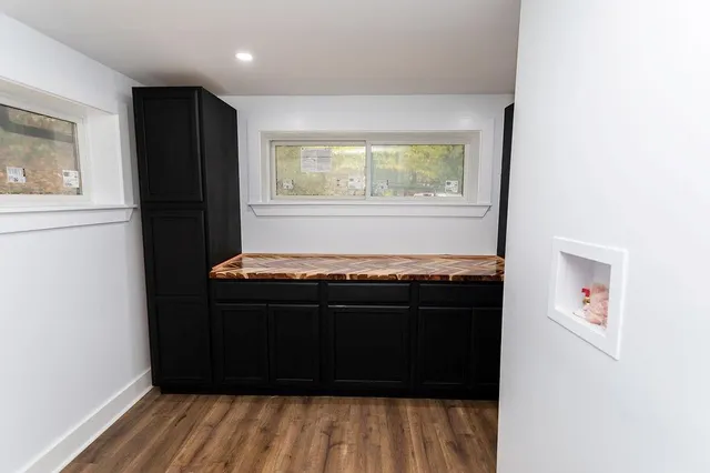 a room with wooden floor and a window