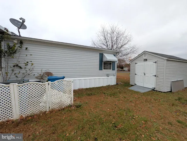 a view of green field with house in background