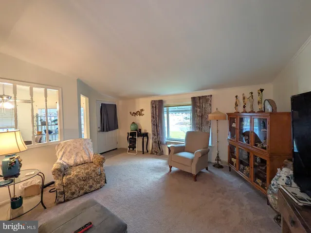 a bedroom with furniture and a large window