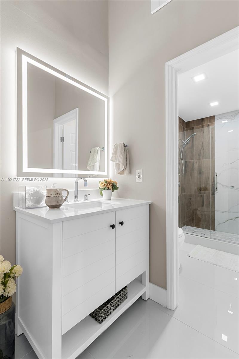 19648 Back 9 Drive, Unit 19648 Boca Raton, FL 33498 - Photo 14 of 39 a bathroom with a sink and a mirror