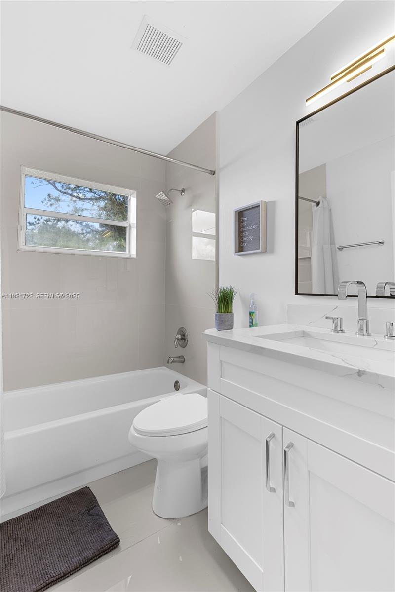 19648 Back 9 Drive, Unit 19648 Boca Raton, FL 33498 - Photo 16 of 39 a bathroom with a sink toilet a mirror and bathtub