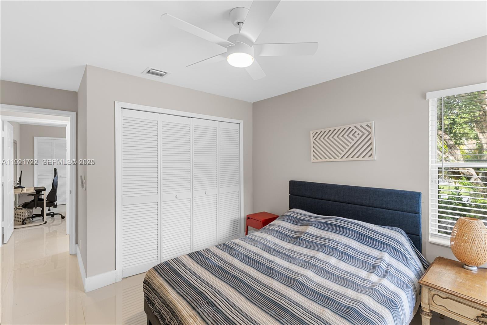19648 Back 9 Drive, Unit 19648 Boca Raton, FL 33498 - Photo 17 of 39 a bedroom with a bed and a chandelier