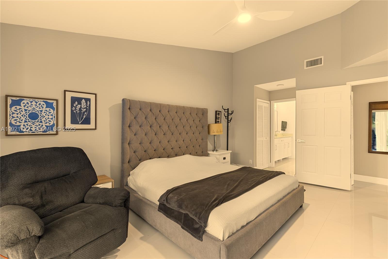 19648 Back 9 Drive, Unit 19648 Boca Raton, FL 33498 - Photo 4 of 39 a bedroom with a bed couch and a refrigerator