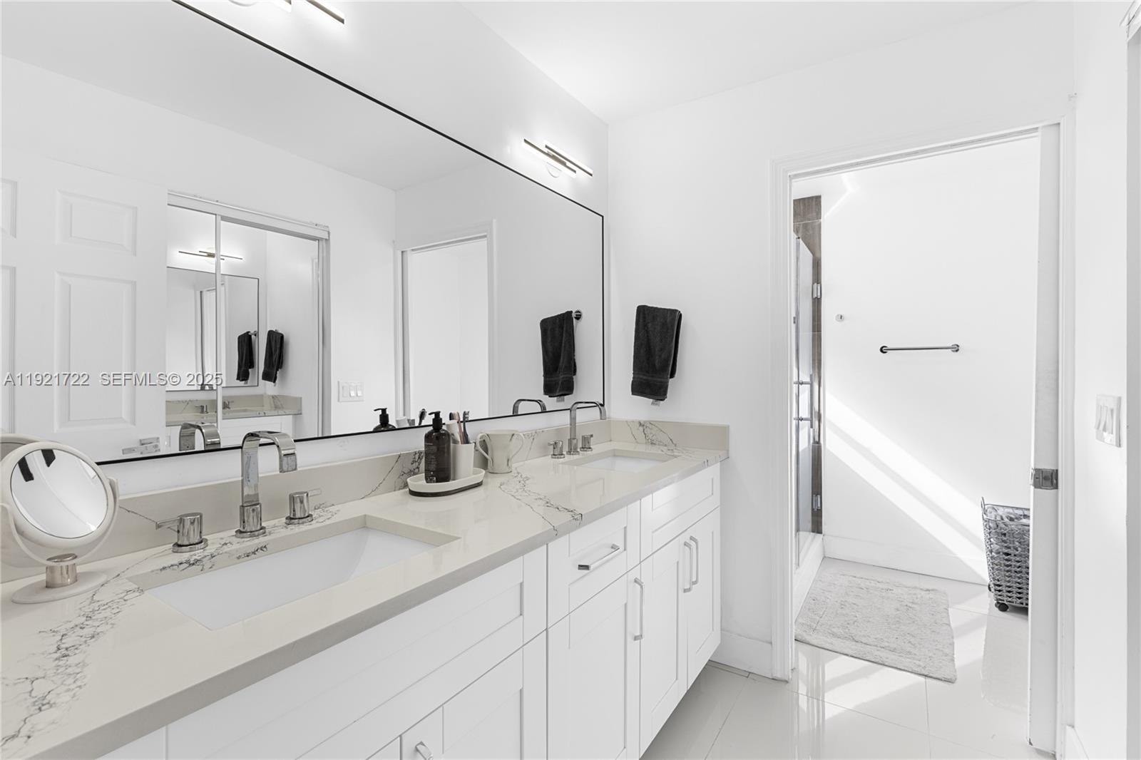 19648 Back 9 Drive, Unit 19648 Boca Raton, FL 33498 - Photo 5 of 39 a bathroom with double sink and a mirror